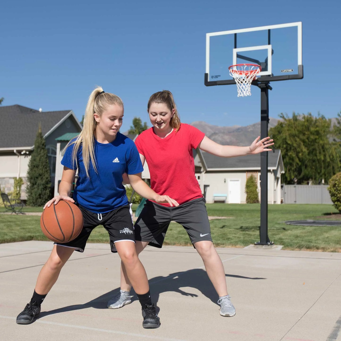 Lifetime 7.5ft. - 10ft. Adjustable Height 60° Tempered Glass Bolt-Down Basketball System (90569)